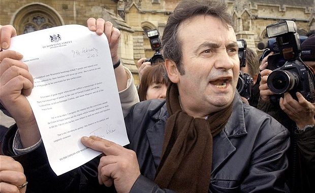 Gerry Conlon showing the letter of apology he received from Tony Blair to media outside the House of Commons in 2005
